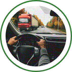Two hands grip a vehicle steering wheel. 
